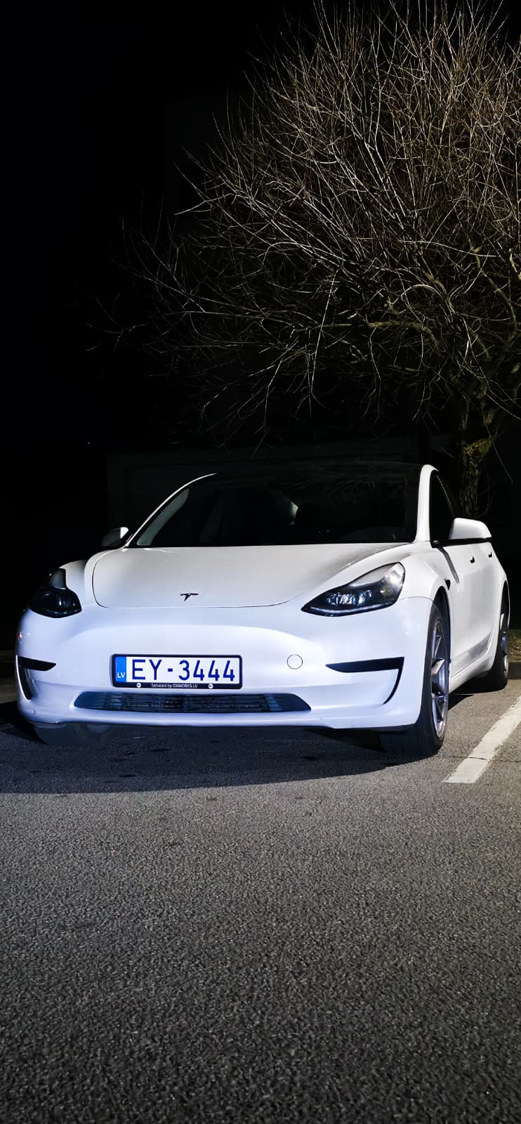 OkoRide Tesla with buildings in Riga
